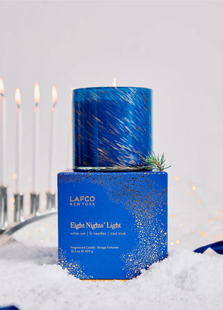 Blue candle with decorative packaging labeled 'LAFCO' on a snowy background
