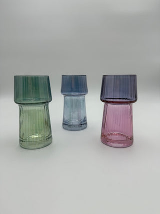 Four multicolored glass vases on a white background