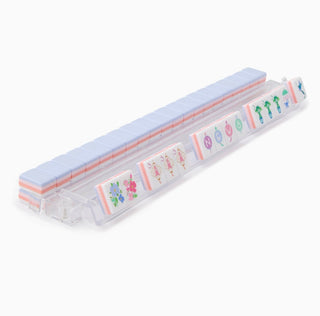 Set of colorful stationery items in a clear holder on a white background