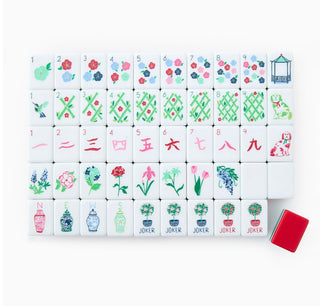 Set of miniature mahjong tiles with colorful designs on a white background