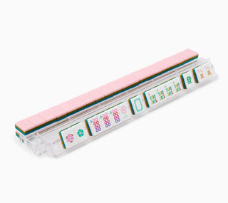 Set of Mahjong tiles in a clear plastic case on a white background