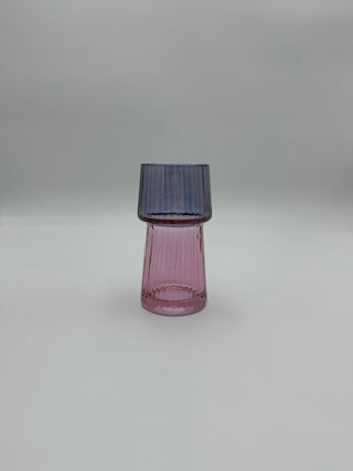 Pink glass object on a gray background