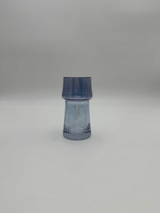 Blue glass vase on a light gray background