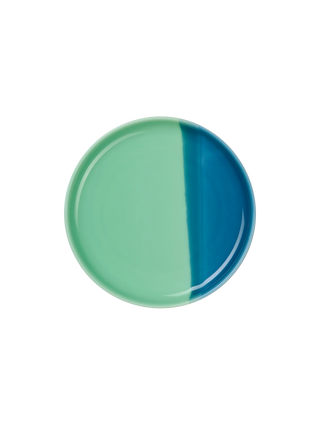 Round ceramic plate with green and blue coloration on a white background