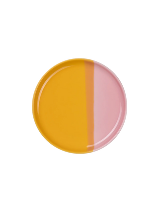 Round ceramic plate with yellow and pink half-circle design on a white background