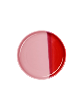 Two-tone pink and red round object on a white background